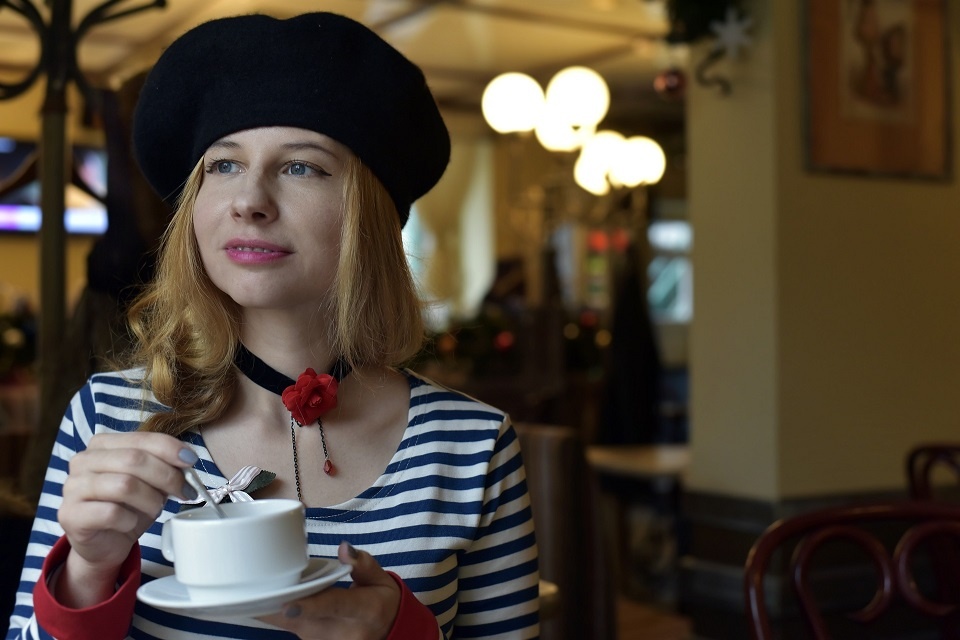 A French Woman with a Coffee wearing a Dark Beret